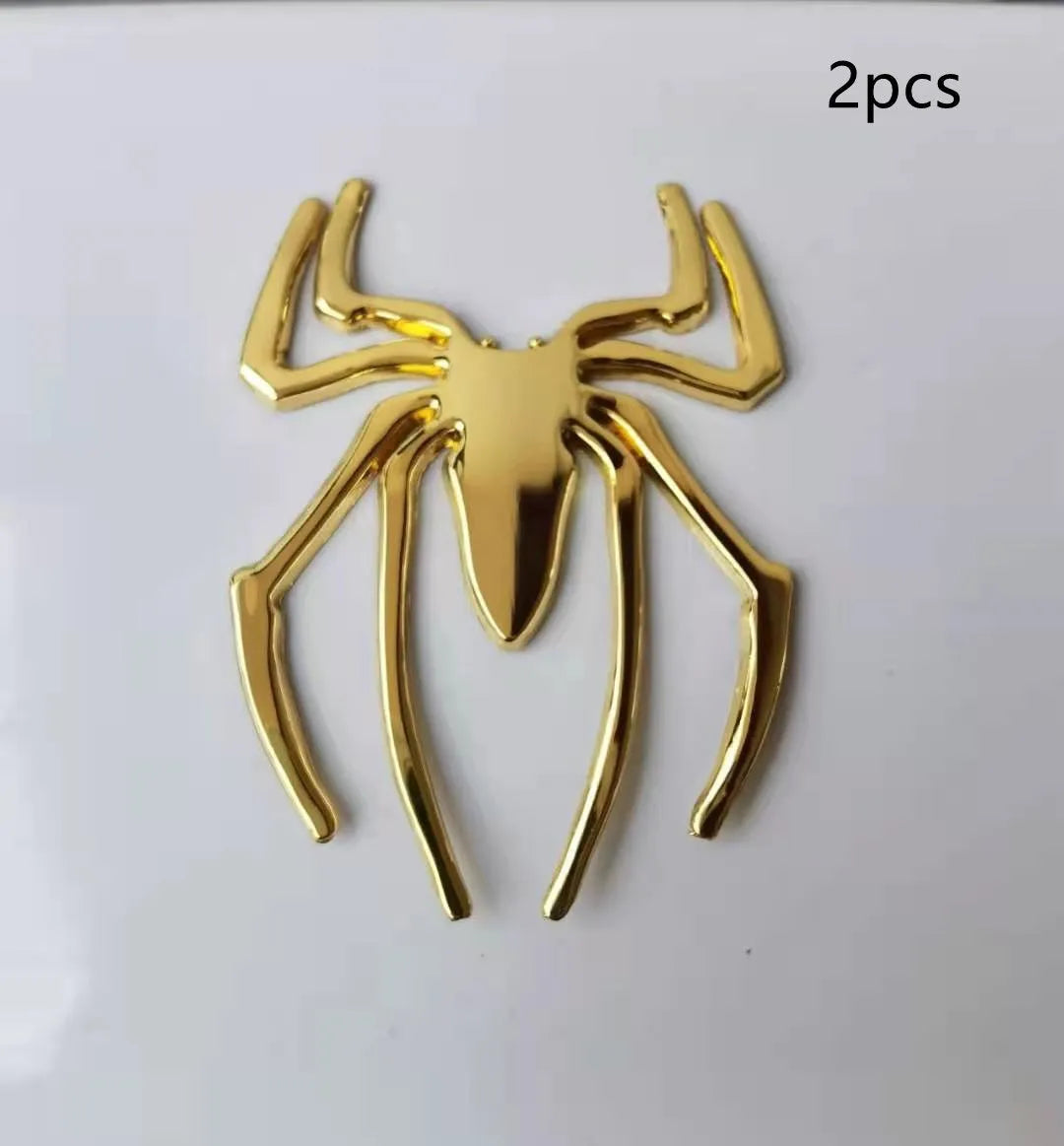 3D metallic spider bumper sticker in gold, silver, black, and red colour options.