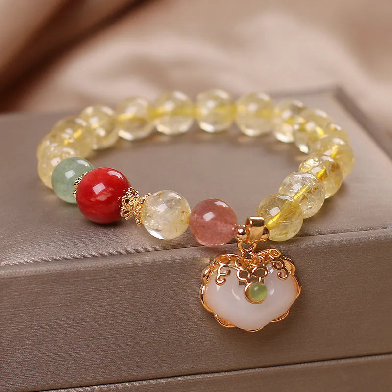 Women's bracelet with a yellow hair crystal jade ruyi pendant on an alloy chain.