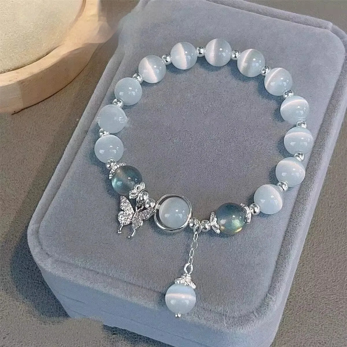 Handcrafted grey moonlight glass butterfly bracelet with coloured glaze beads and round charms