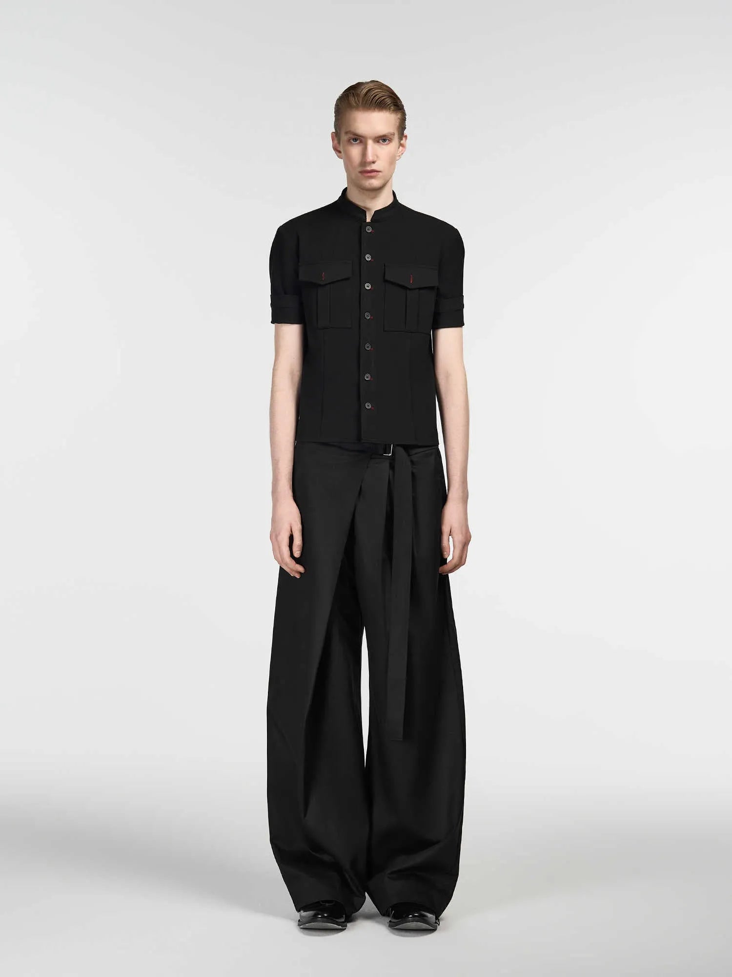 Black straight-leg trousers with a single pleat and adjustable waistband on a hanger