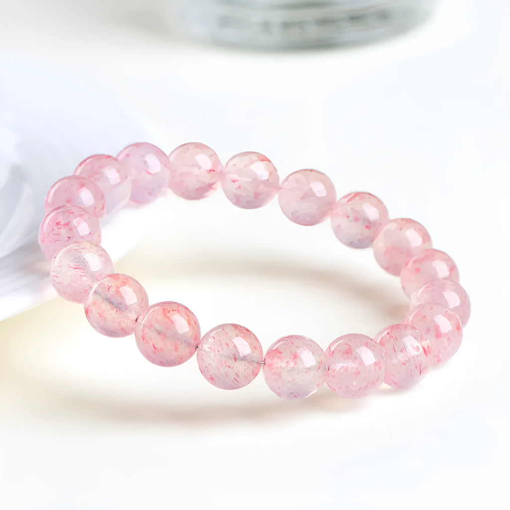 Natural white strawberry quartz ball bracelet with 10-10.8mm spherical beads.