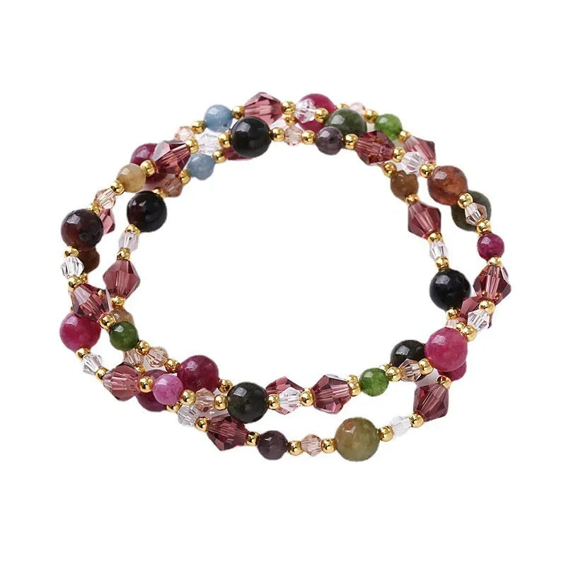 Women's three-ring crystal bracelet with tourmaline, strawberry quartz, and amethyst beads on adjustable cord.