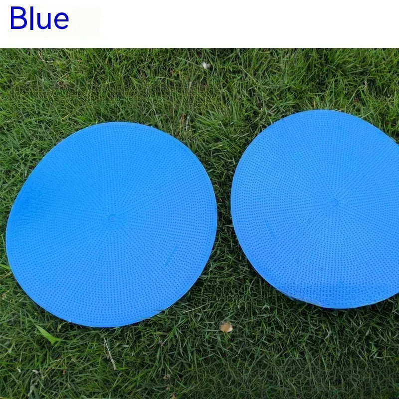 Flat, round yellow football training target disc with 23cm diameter on grass.