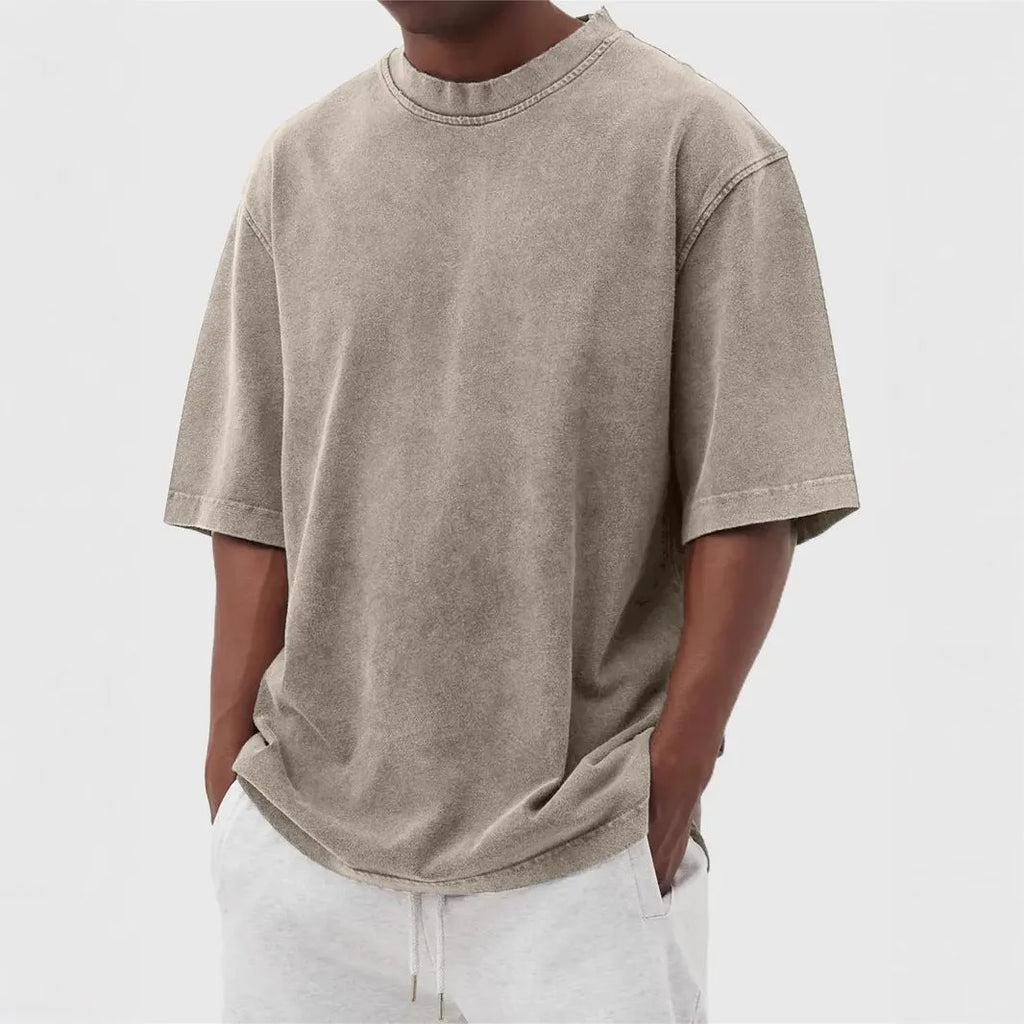 Men's loose fit pullover T-shirt in a stone-washed distressed solid colour, shown in army green.