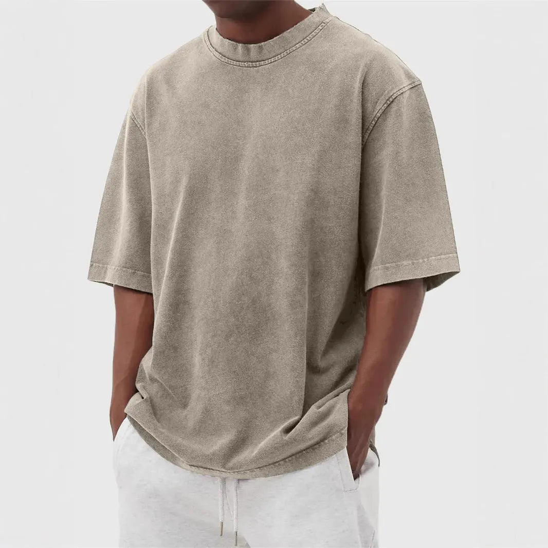 Men's loose fit pullover T-shirt in a stone-washed distressed solid colour, shown in army green.