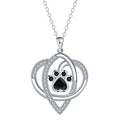 Copper pendant necklace showing a detailed cat and dog paw print design on a cross chain.