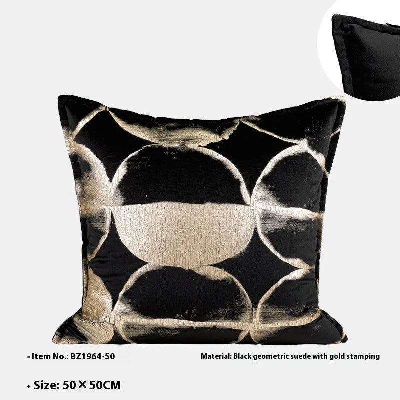 Black and gold abstract patterned decorative cushion on a sofa, available in three sizes with a removable cover.