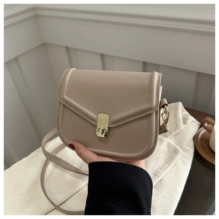 Soft textured PU shoulder messenger bag in horizontal square clamshell design.