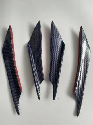 Set of four carbon fibre effect ABS plastic bumper air knife spoilers for car styling.