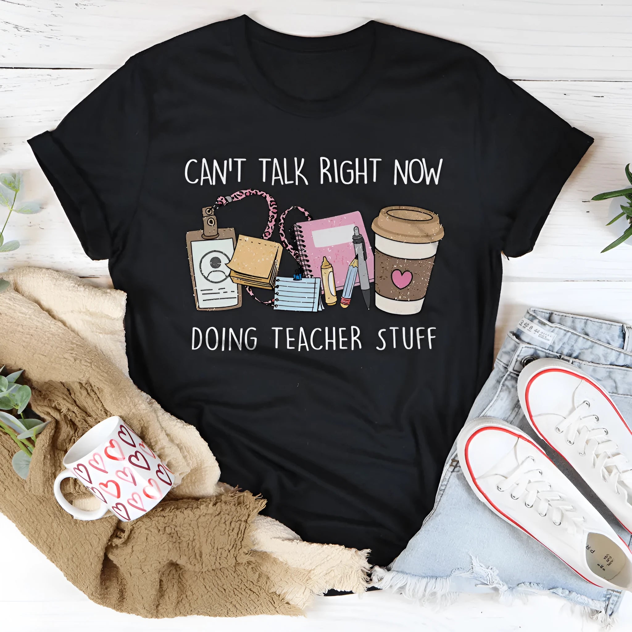 Black straight cut cotton t-shirt with round neck and short sleeves laid flat.
