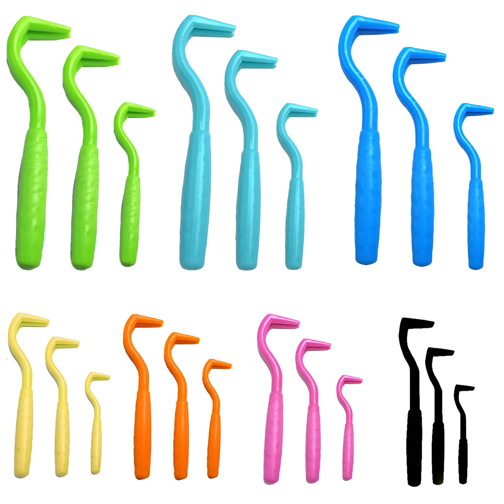 Set of three coloured plastic tick removal hooks for pets on a white background.