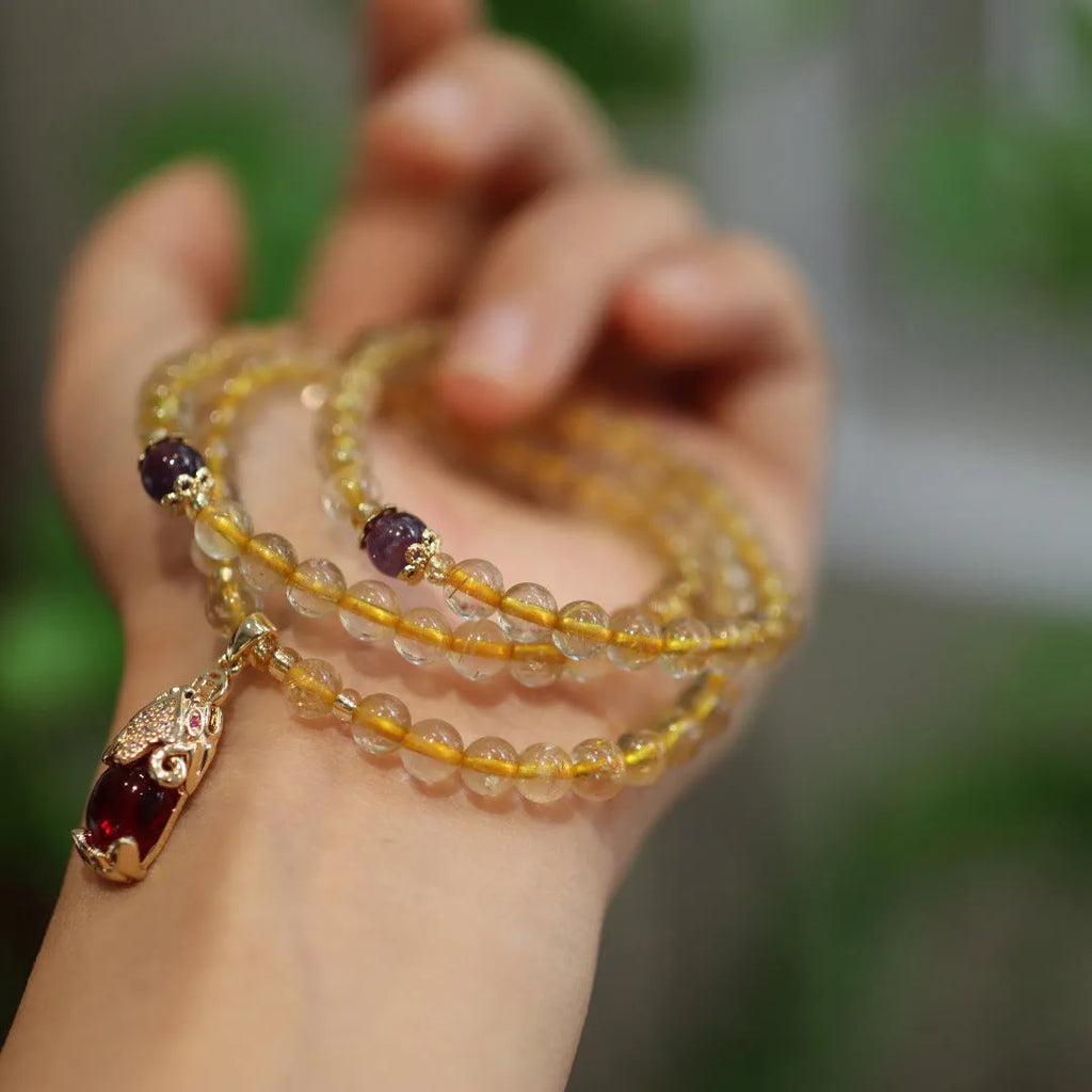 Brazilian Rutilated Quartz bracelet with gold beads and hanging chopsticks pendant