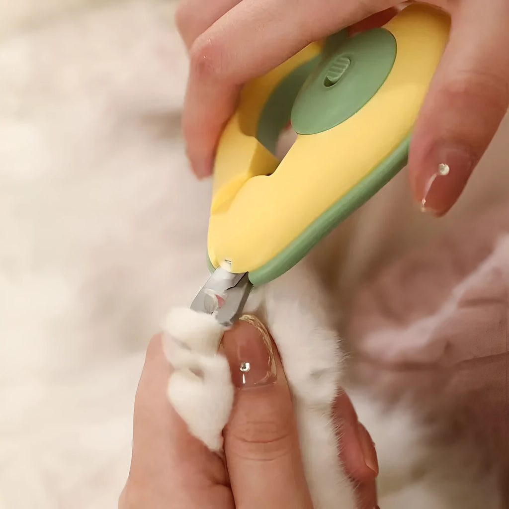 Green pet nail clipper with LED light on, showing scissor design and anti-slip handle for small dogs and cats.