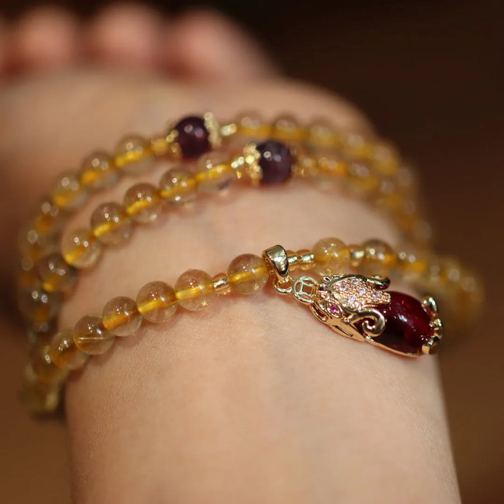 Brazilian Rutilated Quartz bracelet with gold beads and hanging chopsticks pendant