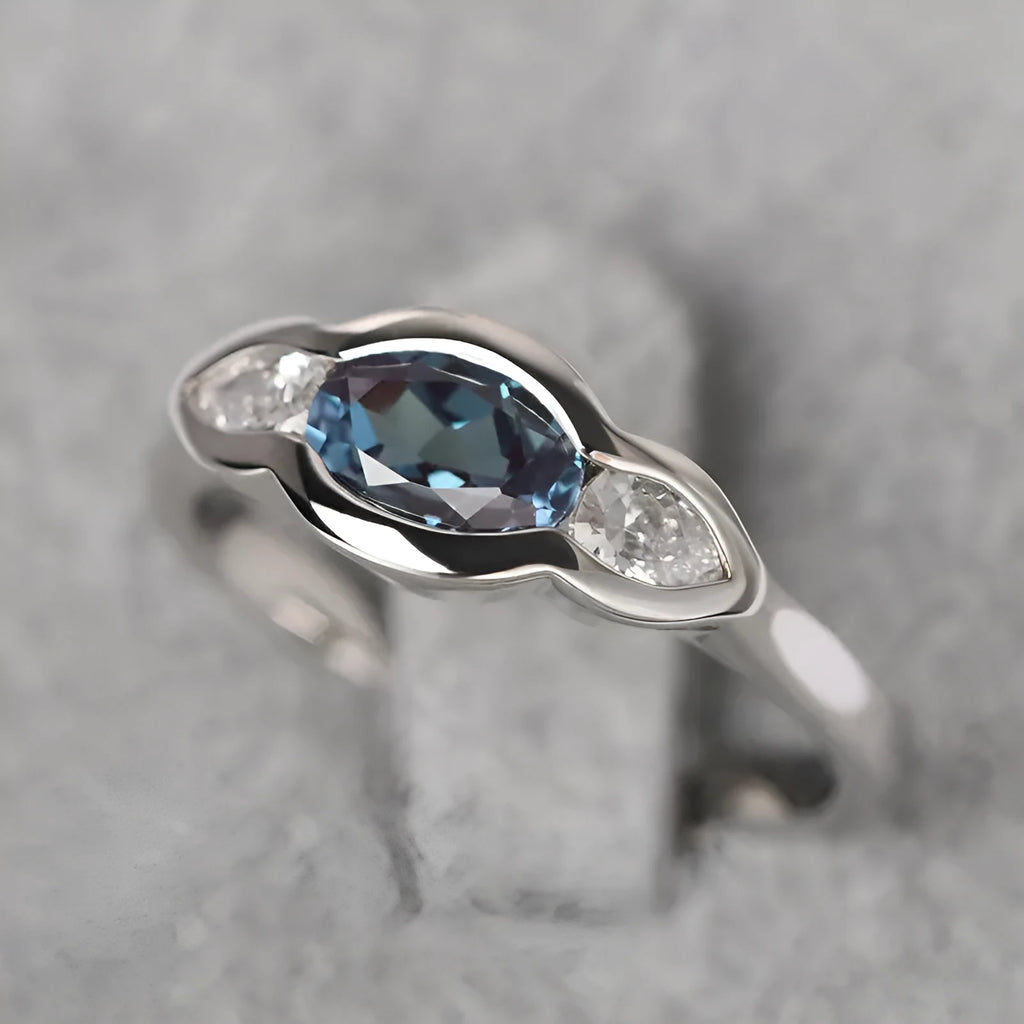 Geometric ellipse women's ring with inlaid zircon stones in white gold colour