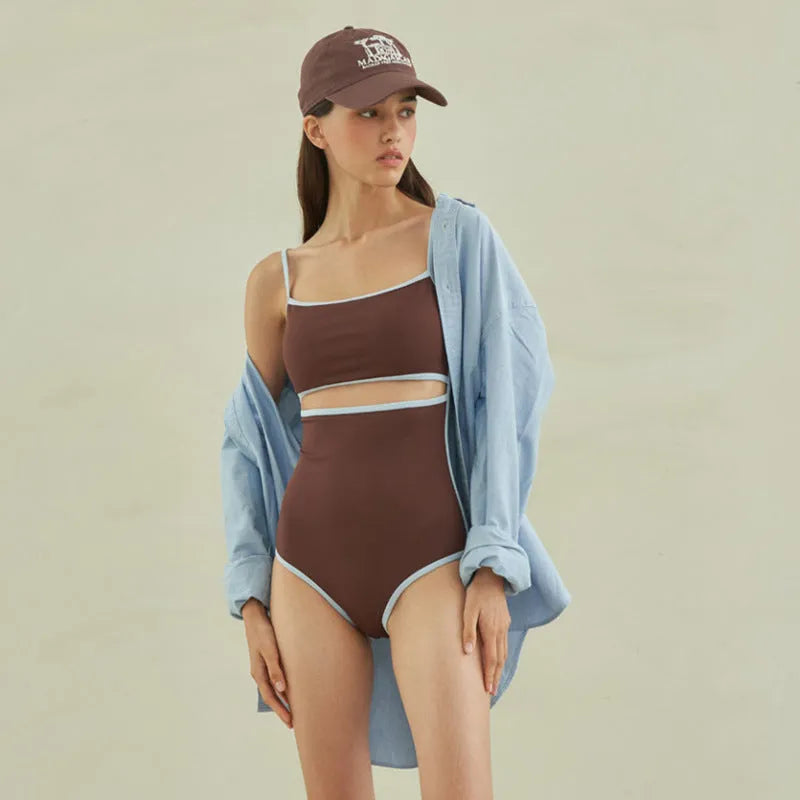 Brown women's one-piece swimsuit with triangle neckline on mannequin