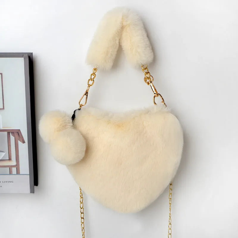 A soft plush heart-shaped women's handbag with a zipper and a detachable shoulder strap in a choice of 14 colours.