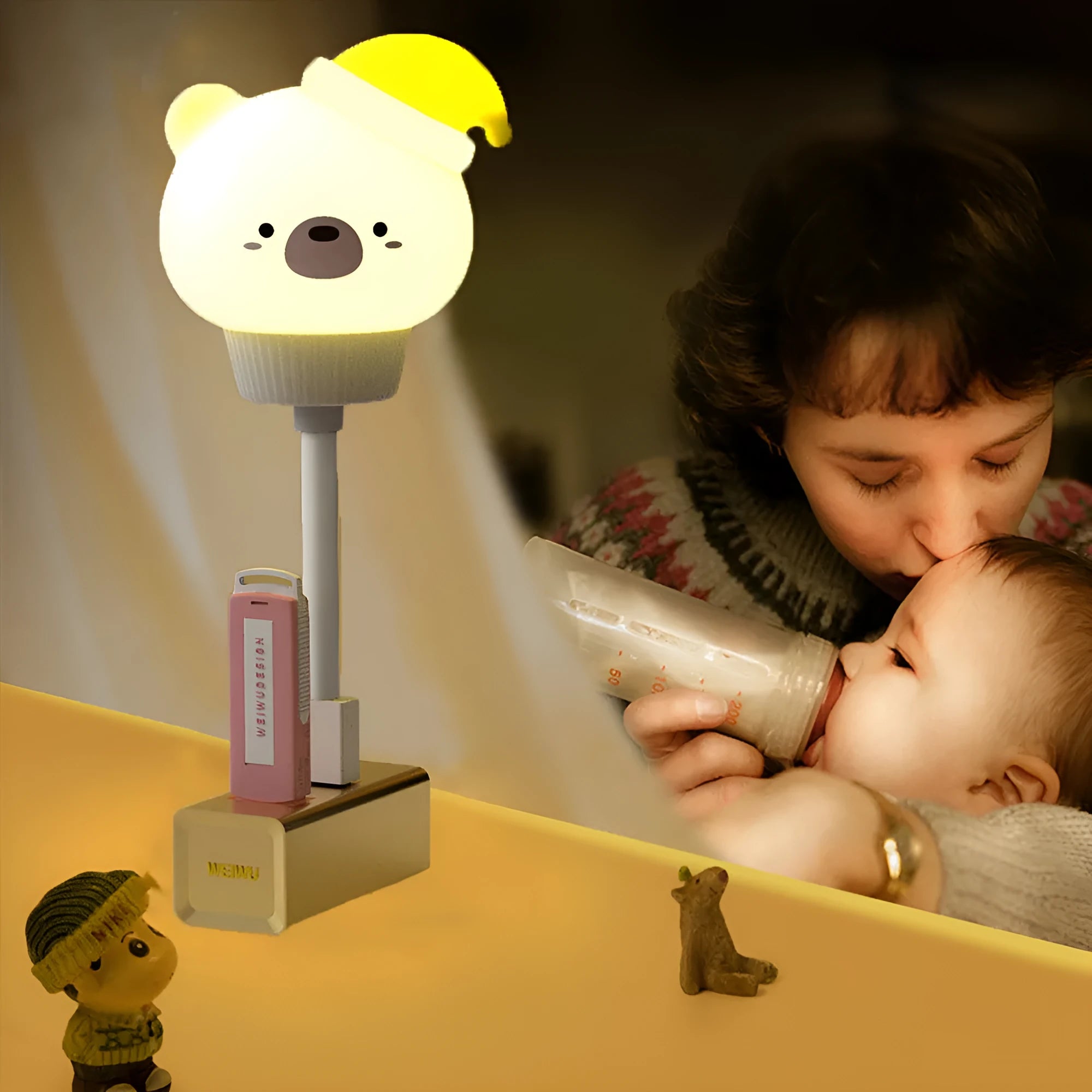 Small cartoon bear-shaped USB night light with remote control on a bedside table.