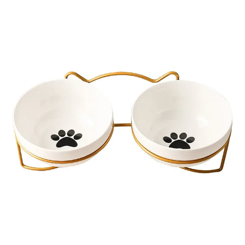 White ceramic pet bowl with cat paw print pattern in black iron frame stand