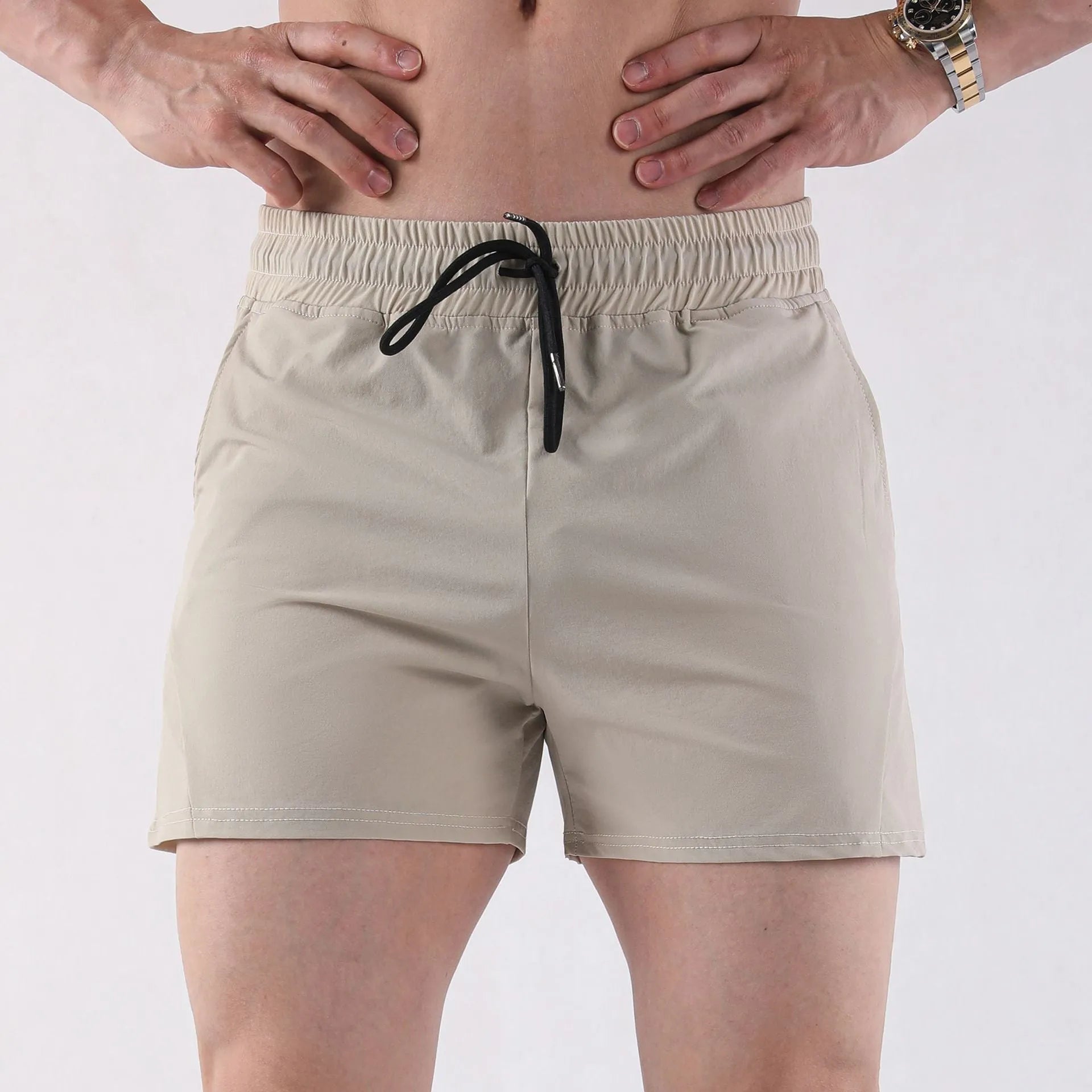 Men's thin grey polyester basketball shorts with elastic waistband on a plain background.