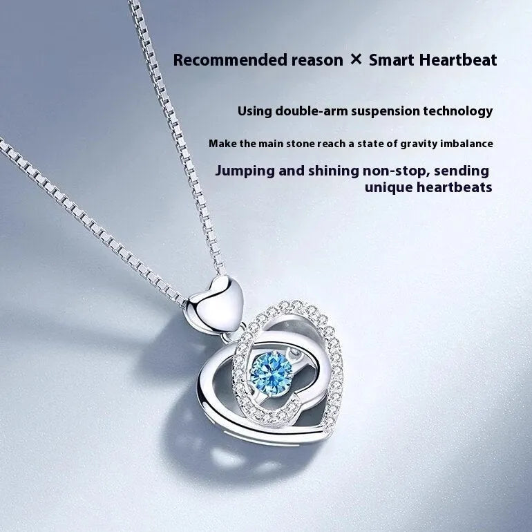 Blue diamond heart-shaped necklace and matching bracelet set with gemstone inlays on a model