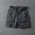 Men's stretch cotton cargo shorts in army green showing multiple pockets and straight-leg fit.