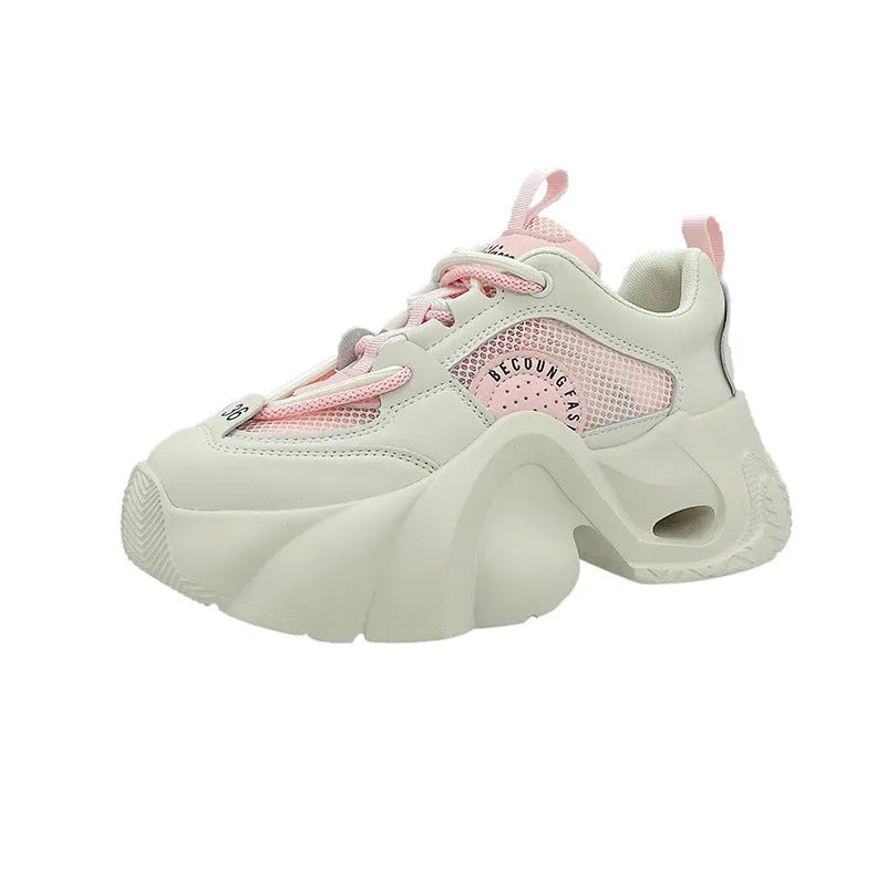 Women's pink casual sneakers with cross strap design and thick sole showing side profile