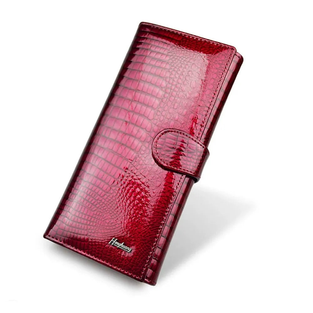 Wine red women's leather coin purse with a shiny crocodile pattern texture and open interior.