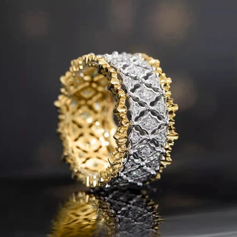Geometric round two-tone gold zircon ring on a plain background, showing its electroplated copper construction.