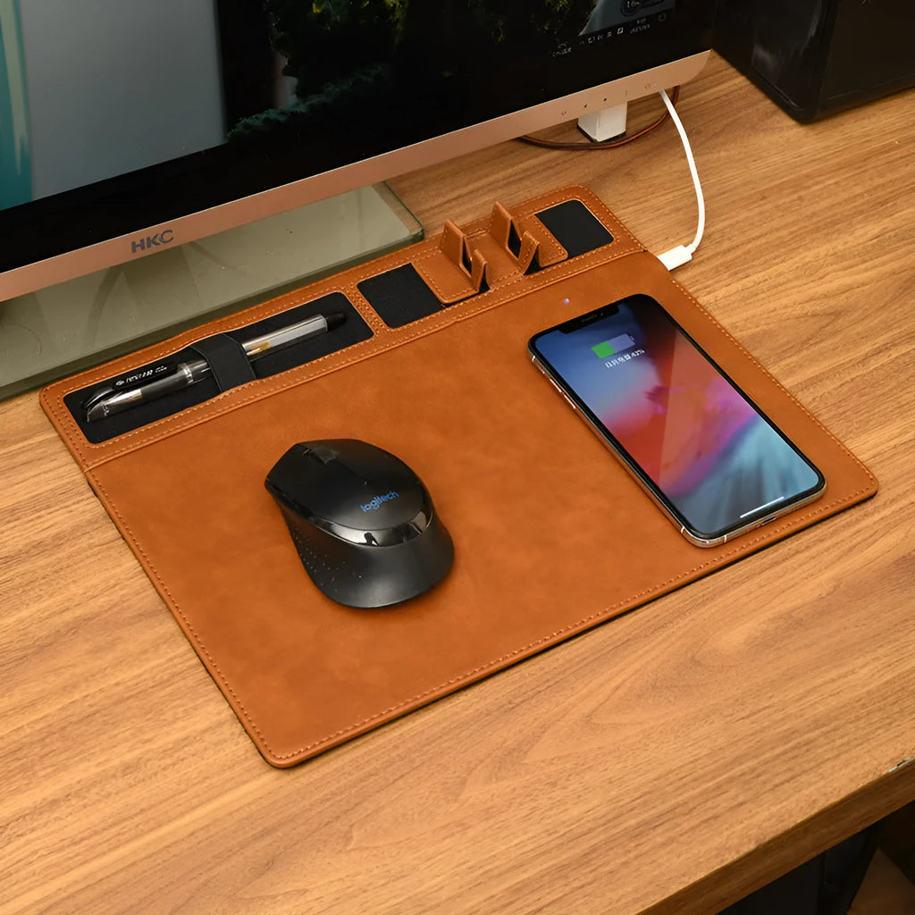 Black wireless charging mouse pad with phone holder on a desk, showing USB cable.
