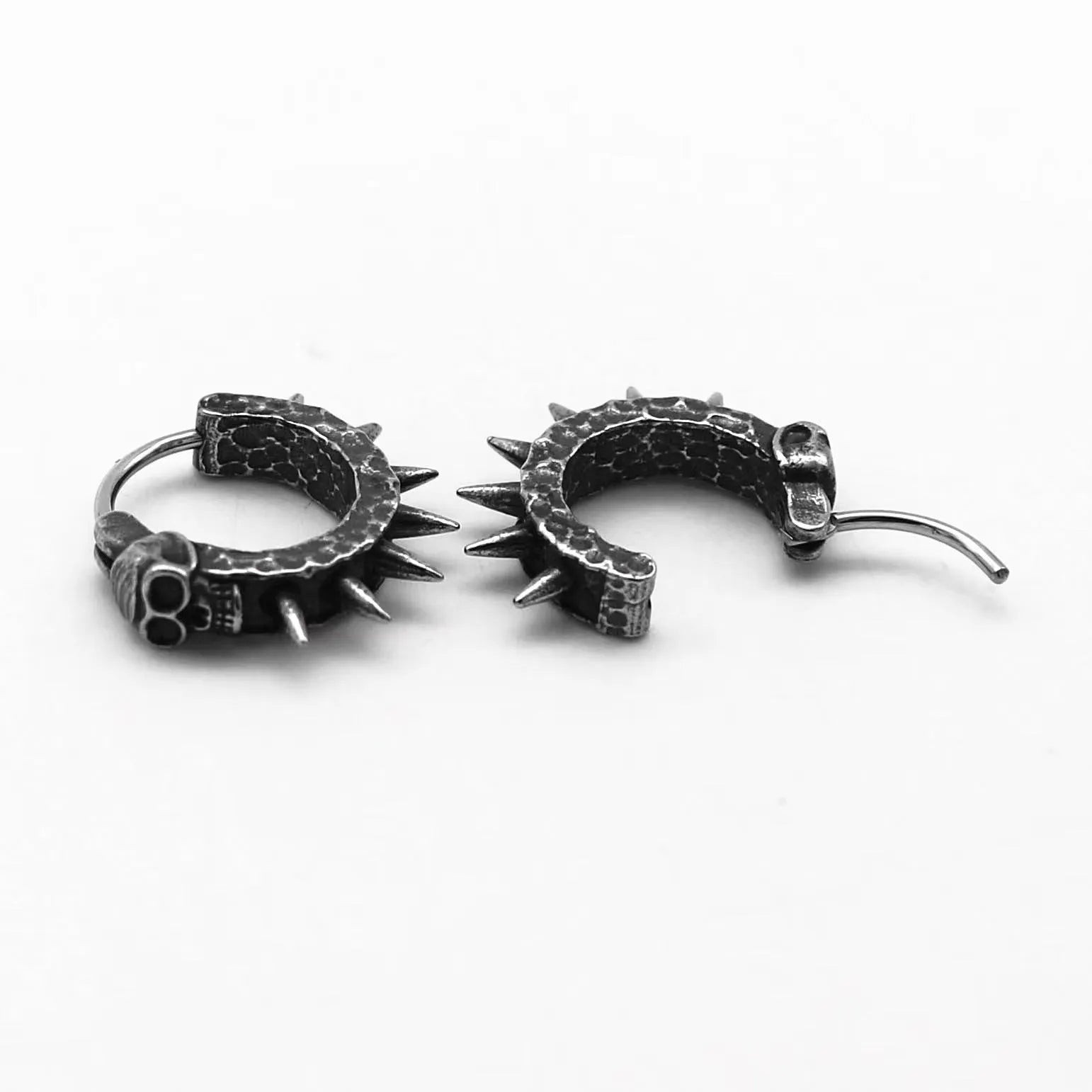 A pair of black alloy earrings with a geometric motorcycle punk design on a white background.