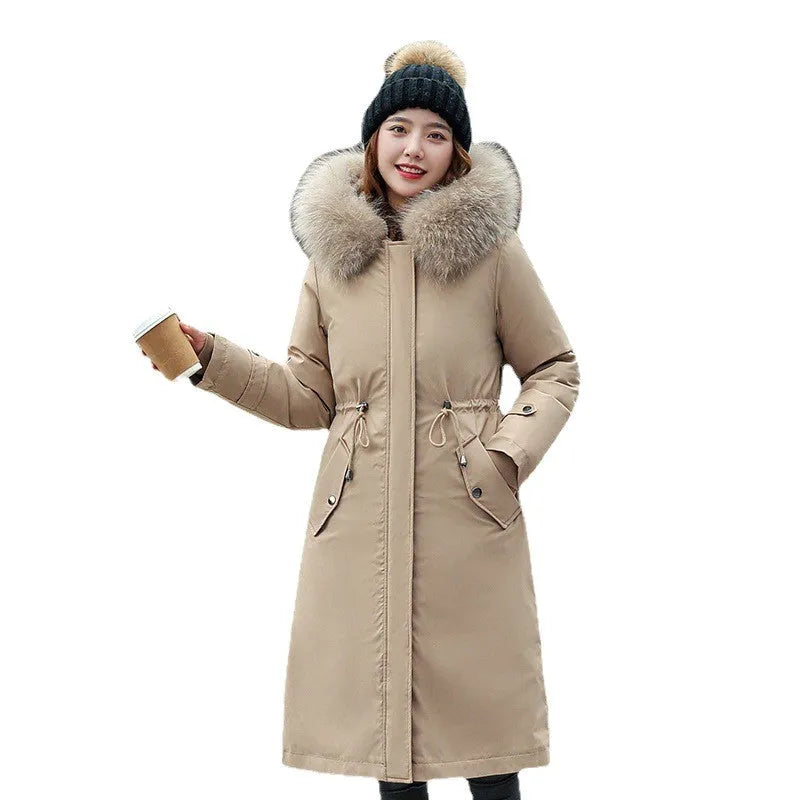 Women's long beige trench coat with fleece lining on a hanger, showing its extended length and elegant style.