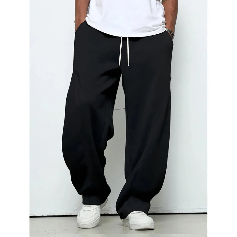 Men's solid colour straight-leg casual trousers with a drawstring waist on a hanger.