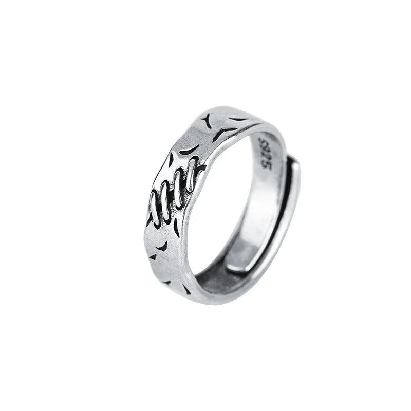 Black geometric copper ring with adjustable opening and oval centre element