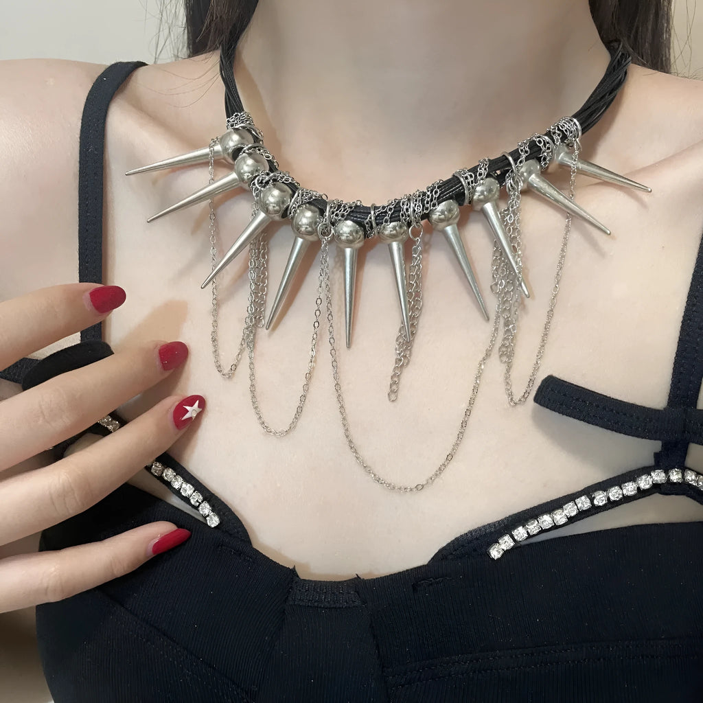 Women's leather necklace with electroplated finish showing rivet decoration and winding tassel design with round beads