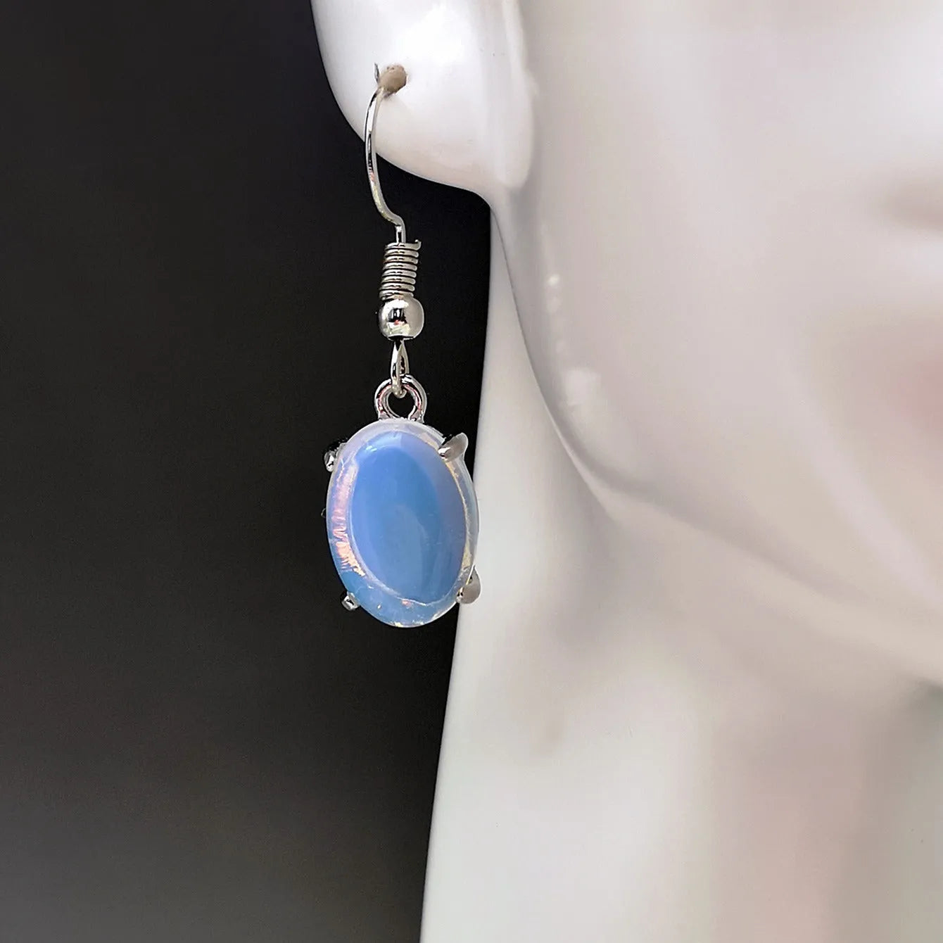 Opal earrings with retro moonstone cross design and ellipse elements in drop shape