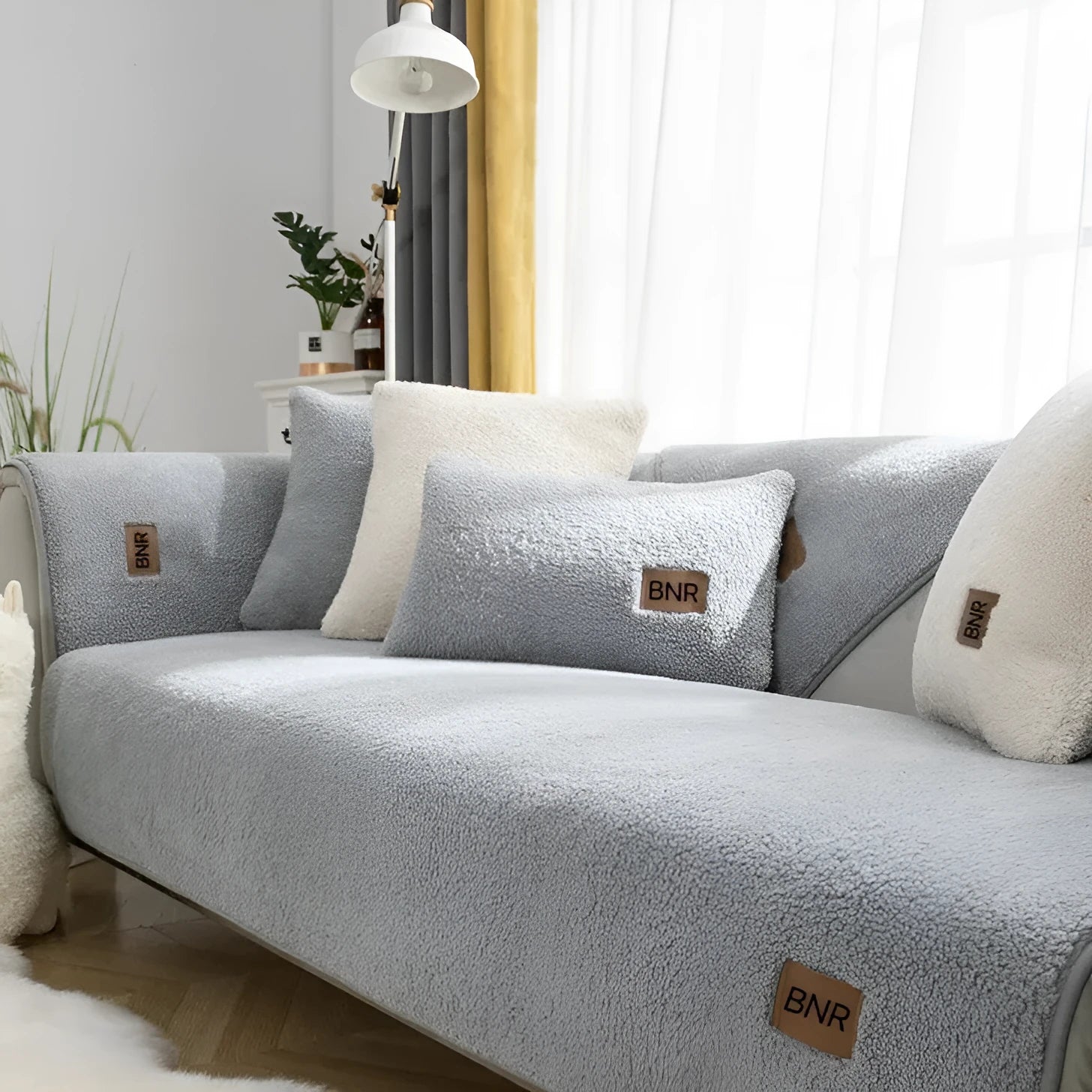 Lambswool sofa cover in solid blue colour on a three-seater sofa