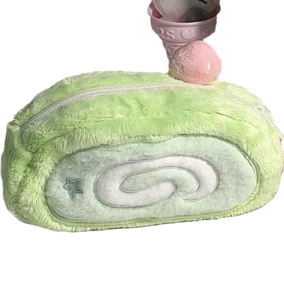 Honeydew Swiss roll cake design velvet pencil case on a flat surface