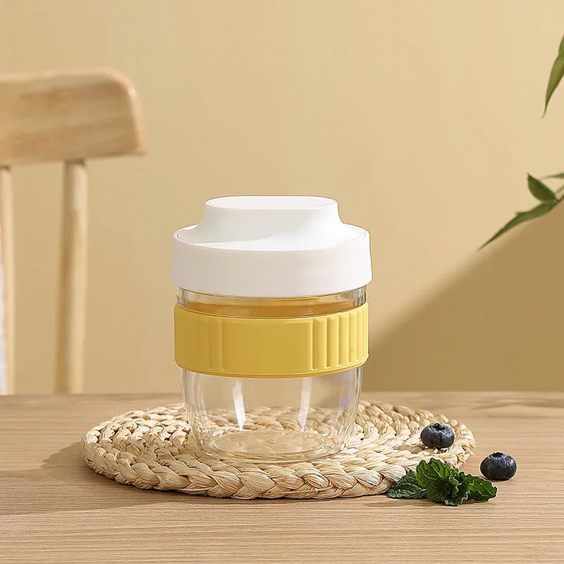 Green plastic salad cup with clear lid and spoon, sealed leak-proof design.