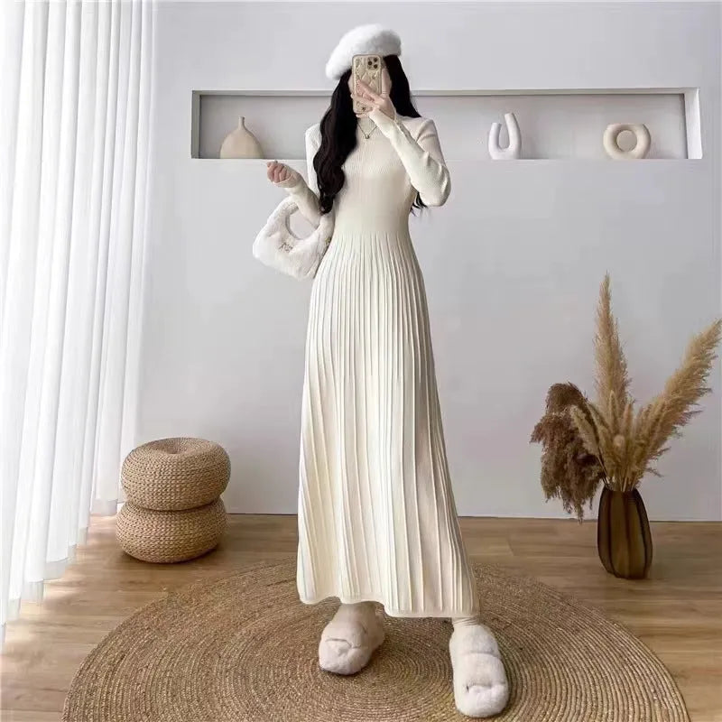 Women's beige high waist A-line knitted midi dress with regular sleeves on a mannequin.