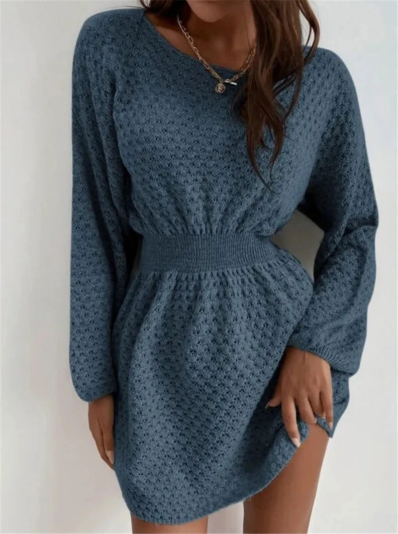 Blue women's knitted dress with hand-crocheted flowers, fitted waist, and loose round neck.