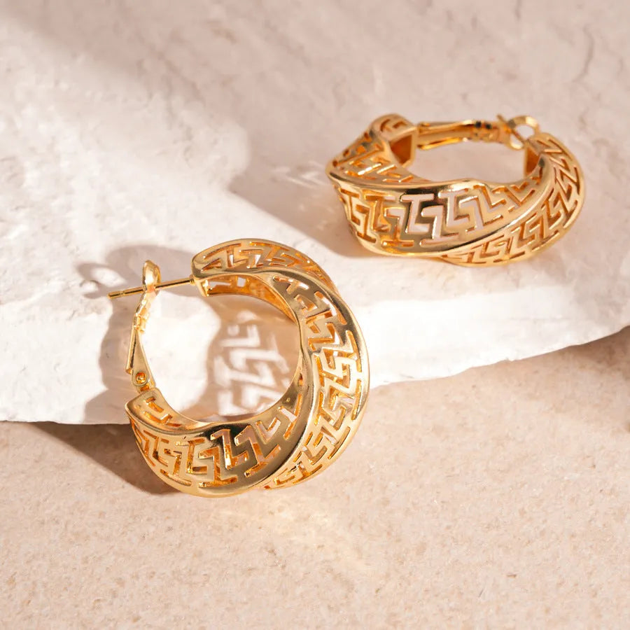 Geometric hollow stud earrings with twisted round design in gold or silver finish