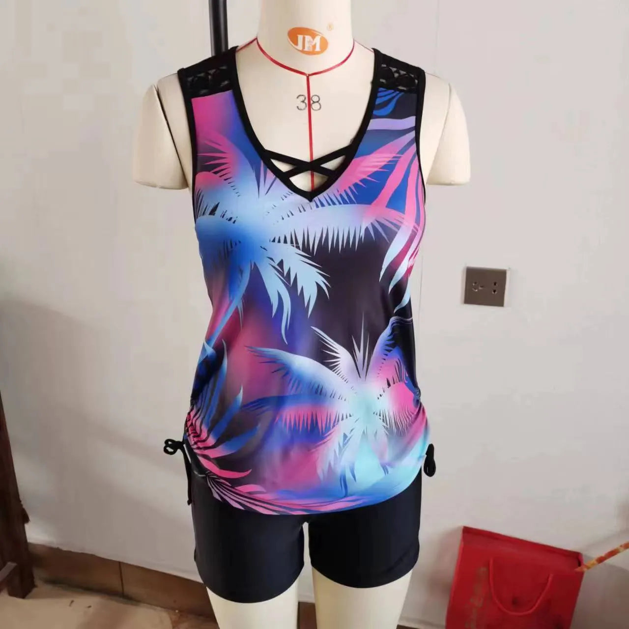 Women's floral printed two-piece swimsuit with sleeveless top and matching shorts in blue or green