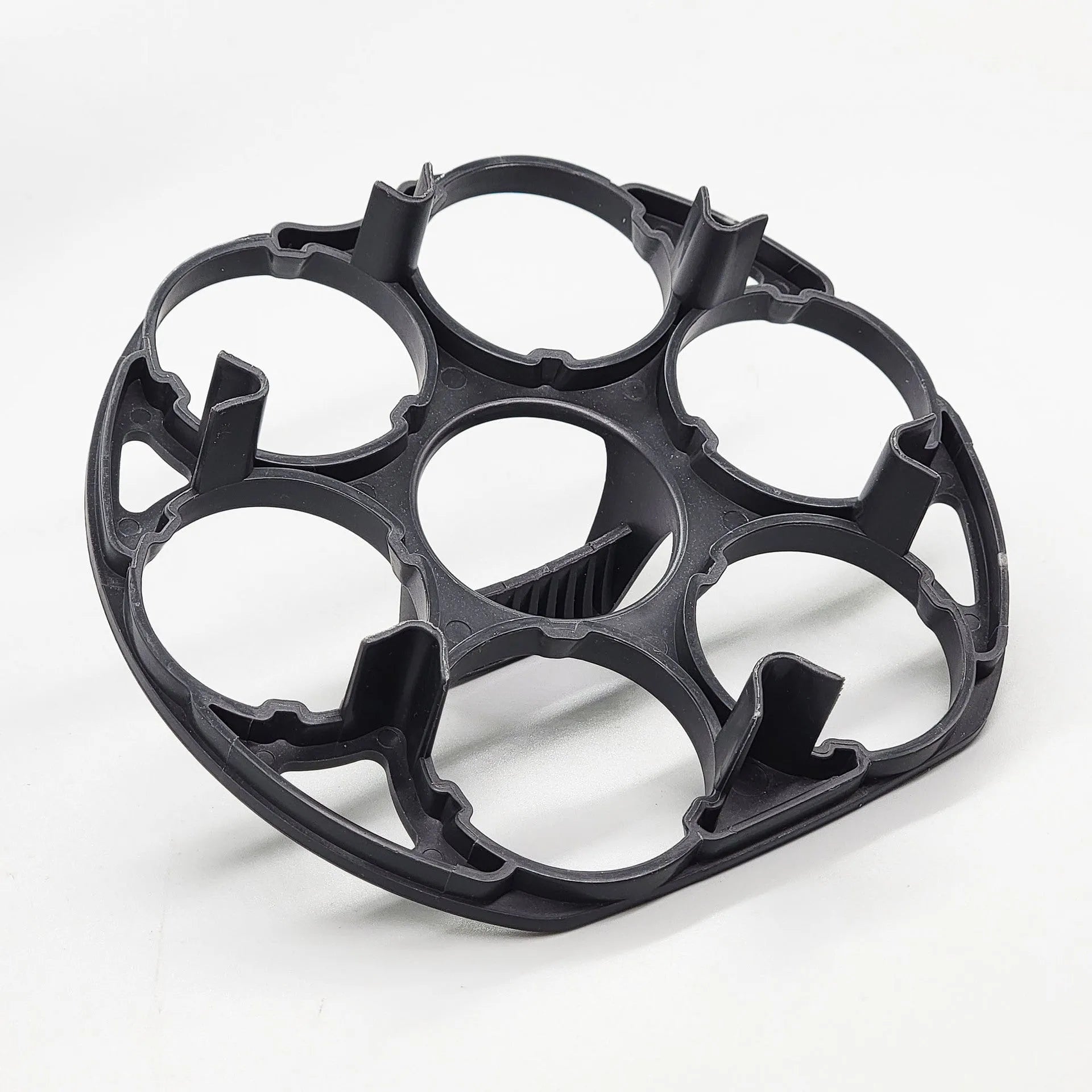 Black plastic egg holder cooking basket rack with modern design on a white background.