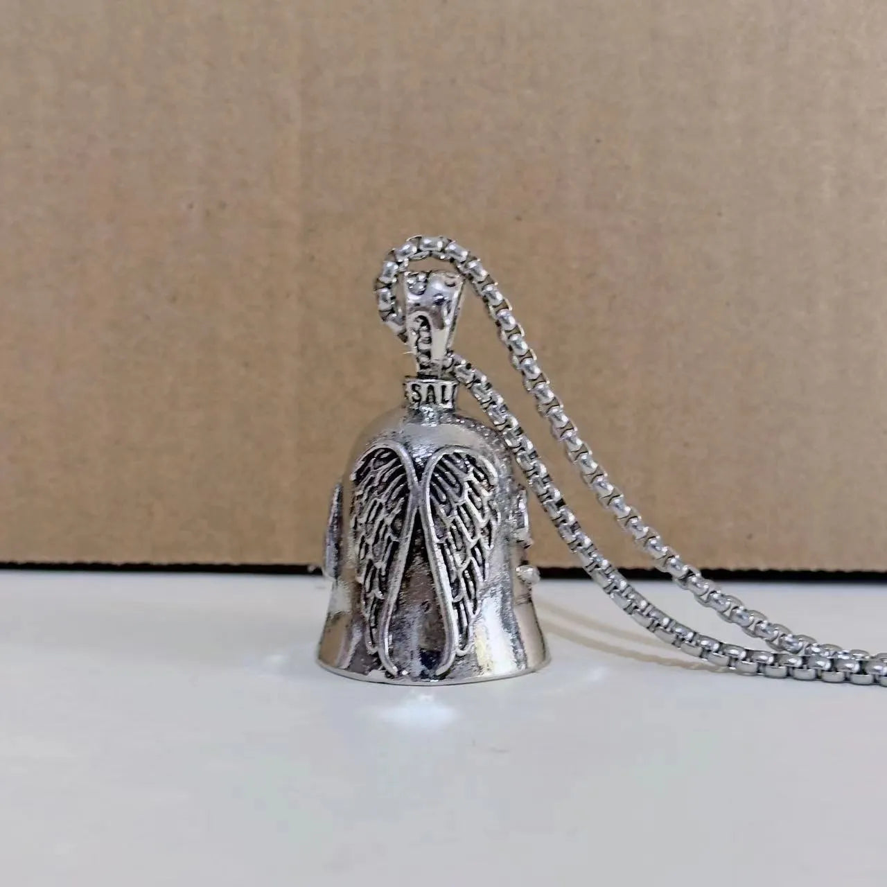Silver-tone vintage angel feather and wings design necklace pendant and matching keychain.