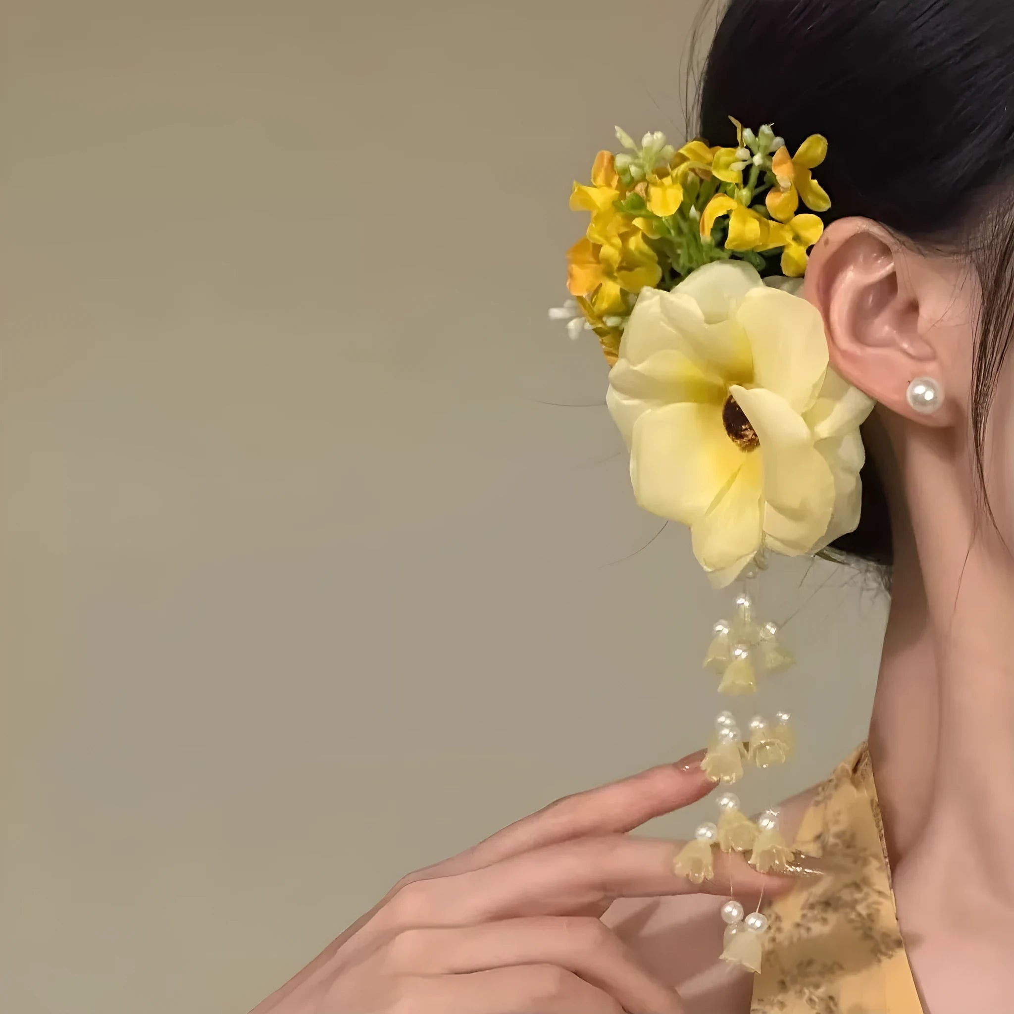Yellow flower tassel hair clip with pearl and linglan elements on white background