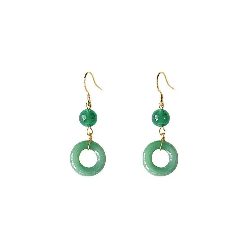 A pair of green geometric Peace Buckle-shaped earrings inspired by traditional Chinese cheongsam design.