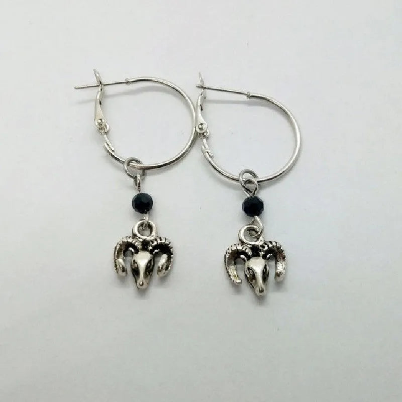 A pair of silver round hoop earrings for women with Tibetan antelope and Western style influences.