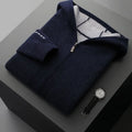 Man wearing a dark blue zip-up cardigan sweater with a half-high collar.