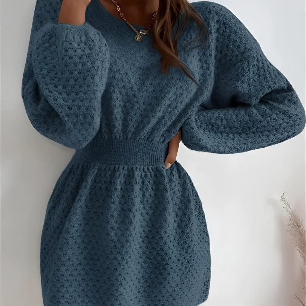 Blue women's knitted dress with hand-crocheted flowers, fitted waist, and loose round neck.